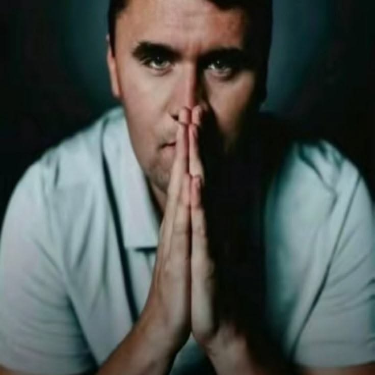 Charlie Kirk with his hands together